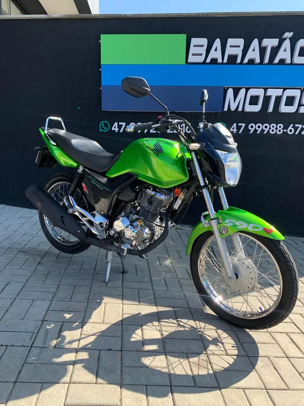 Uma motocicleta verde e preta com as cores verde neon e preto
